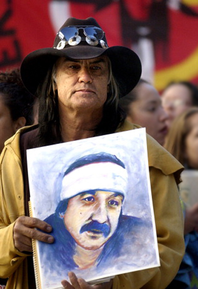 DENVER, CO, SEPTEMBER 19, 2003_David  Hill  the National Director of the Leonard  Peltier  Defense  Committee  holds a portrait of Peltier during a rally outside the Federal Court House in Denver, CO. Leonard Peltier is included in